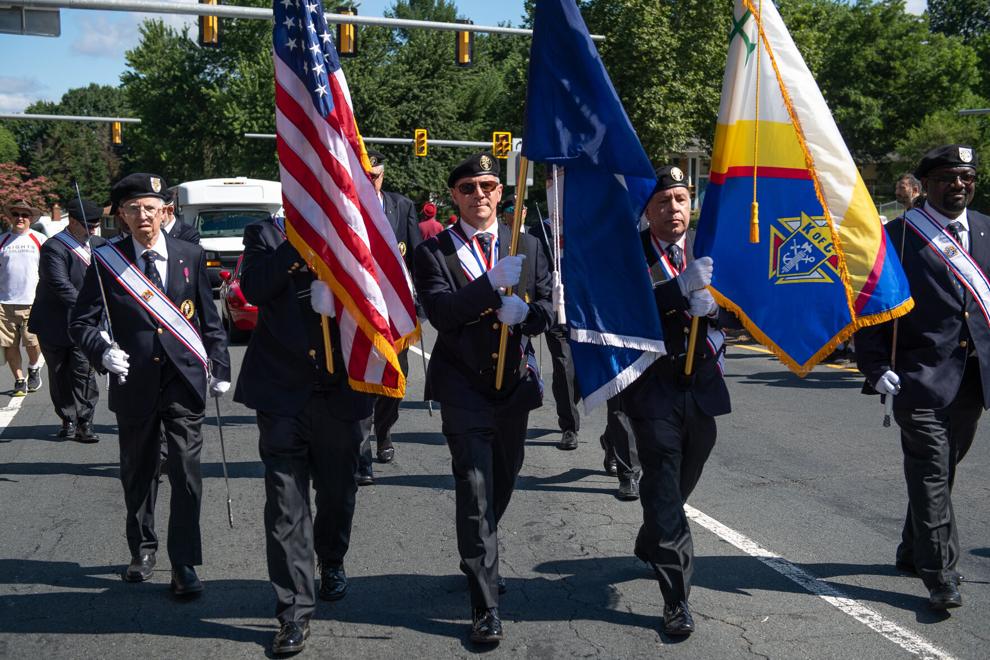 Sir Knights in Regalia carrying flags at a parade